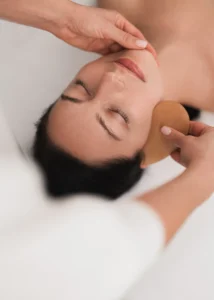 crop-professional-cosmetician-using-gua-sha-tool-d